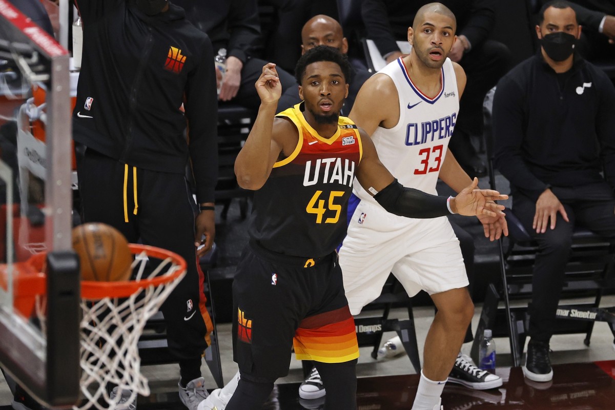 Donovan Mitchell (45) scores a three-pointer over Nicolas Batum (33) in game one of the Western Conference Semifinals